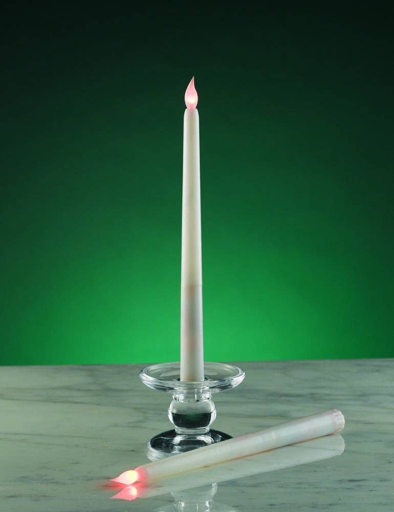 Two Candles: Flameless LED White Wax Dipped Taper Candles (Set of 2) are shown—one upright in a glass holder, the other lying on marble. Both have red-lit tips and are set against a green background.