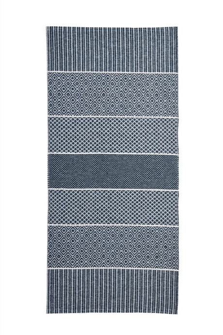 The Horredsmattan - Alfie vinyl rug is a blue Swedish creation that combines traditional woven vinyl craftsmanship with modern design, displaying alternating striped and diamond patterns.