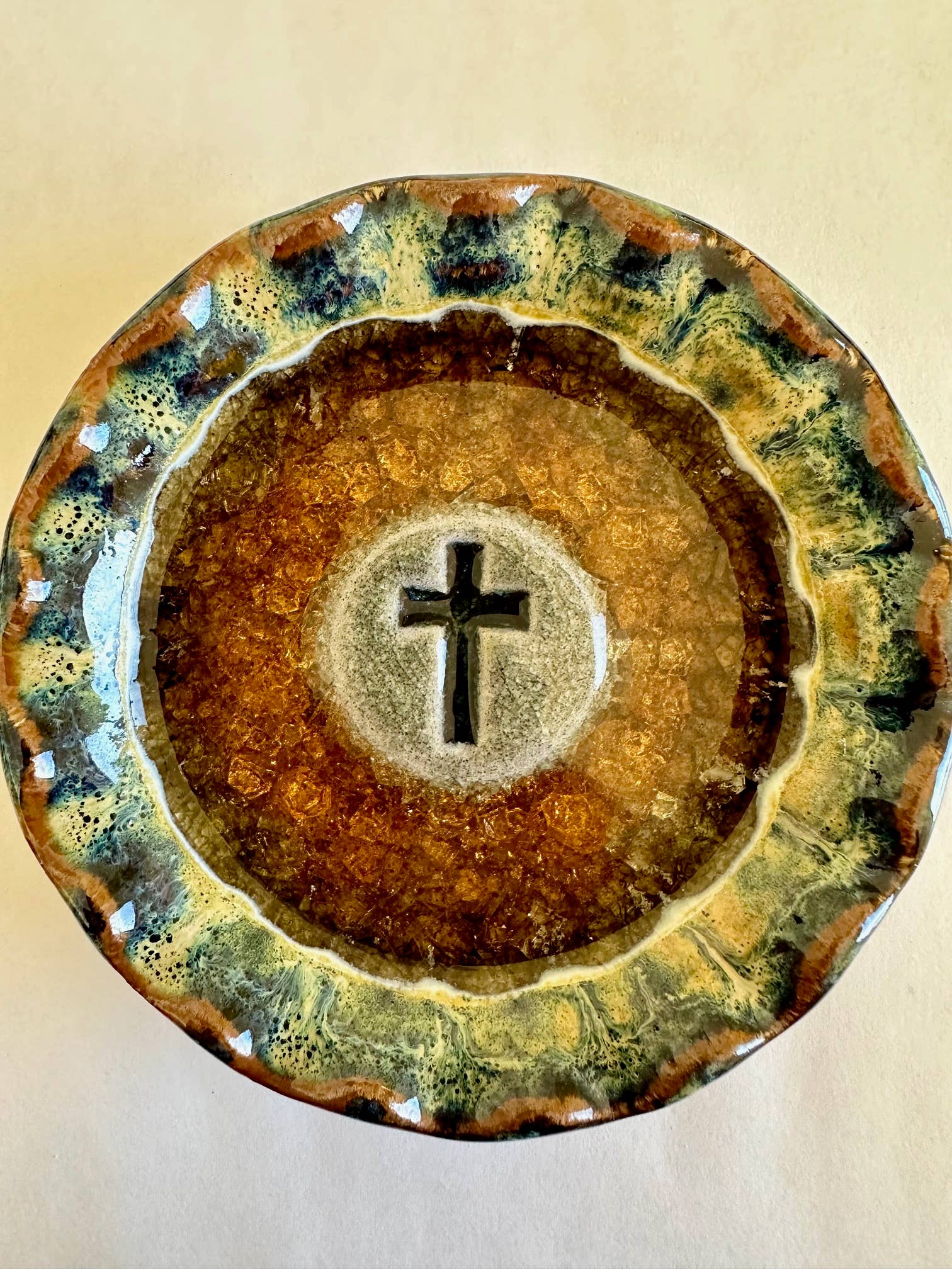 Handmade Cross Dish—crafted from recycled glass and clay—with a textured glaze in brown and green, 4.5" diameter; a unique pottery addition to any collection.
