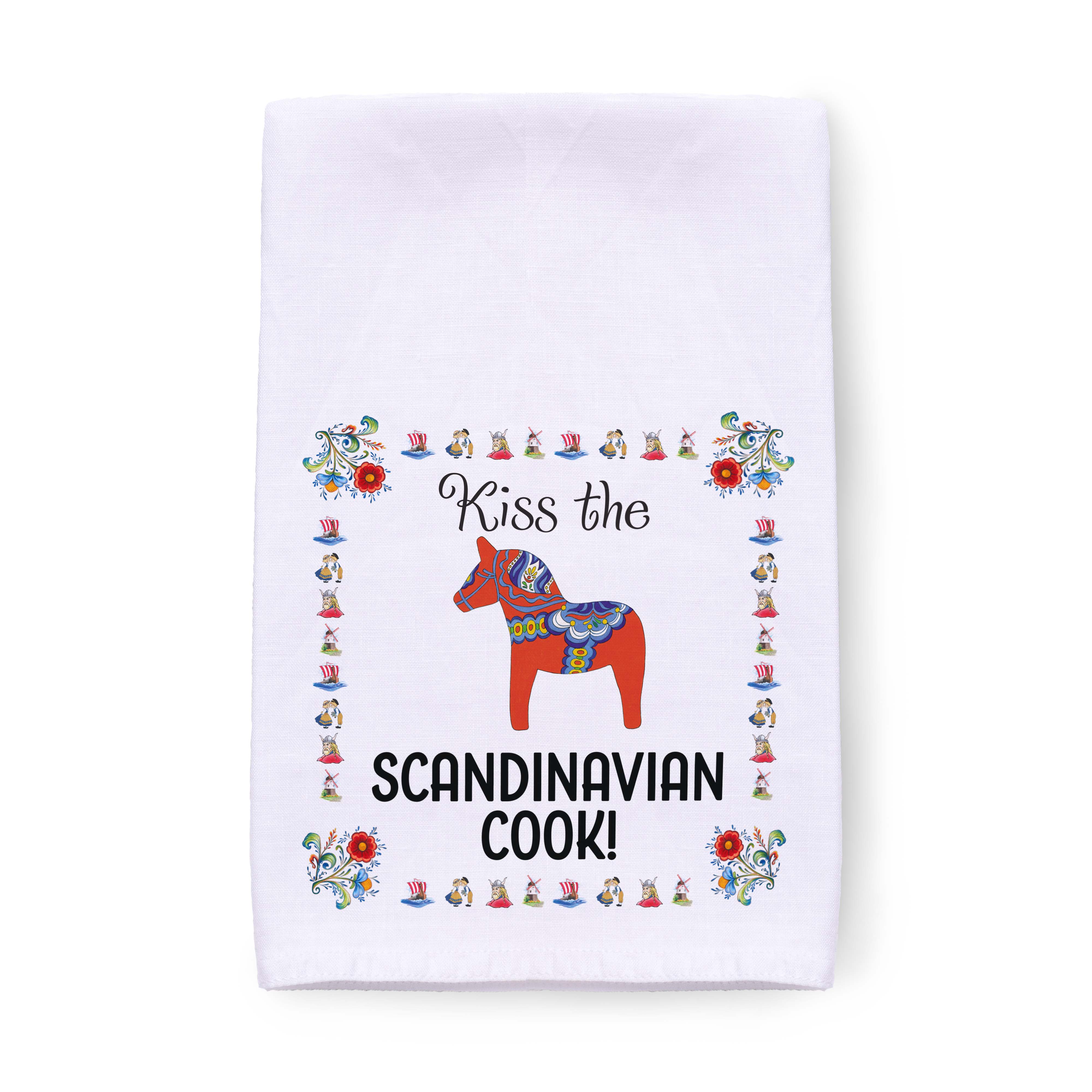 Tea towel featuring the text "Kiss the Scandinavian Cook!" and a charming decorative red horse, surrounded by colorful floral patterns. Ideal as a Scandinavian kitchen gift, this towel enhances any kitchen decor with its charm and vibrancy.