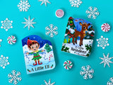 Three board books titled A Little Elf, A Little Reindeer, and Santa’s Sleigh surrounded by snowflake cutouts and peppermint candies on a teal background.