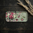 Rectangular Nordic birch veneer tray with a floral pattern, placed on a dark wood surface next to several dried wheat stalks.