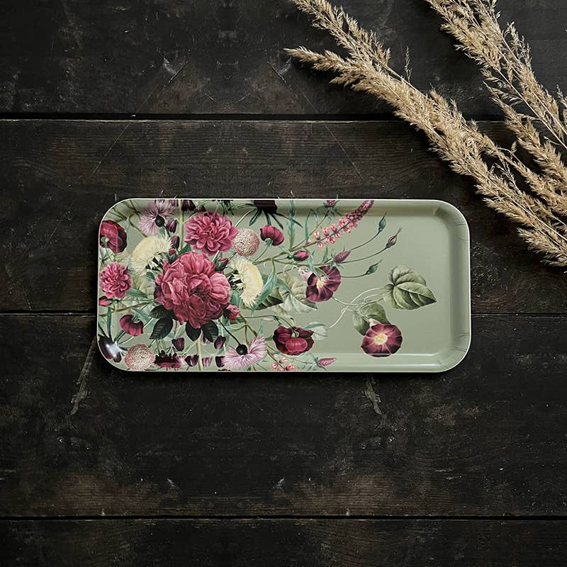 Rectangular Nordic birch veneer tray with a floral pattern, placed on a dark wood surface next to several dried wheat stalks.