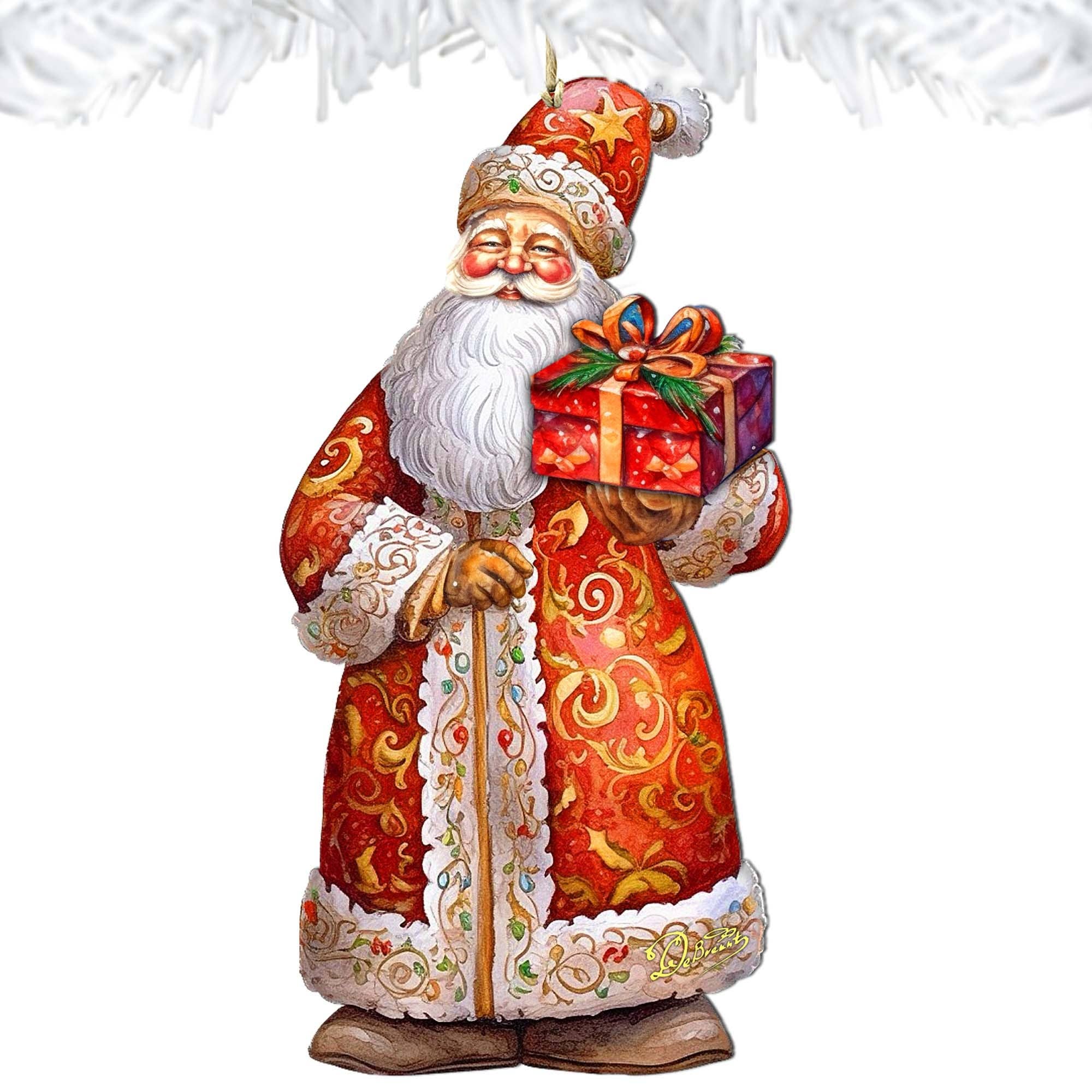 The St. Nick's Gift Wood Ornament by GDebrekht introduces a festive element to your Christmas holiday decor, showcasing a Santa Claus figurine in an ornate red and gold suit holding a wrapped gift. A white garland embellishment at the top enhances any Santa Snowman décor arrangement, adding cheerful holiday vibes.