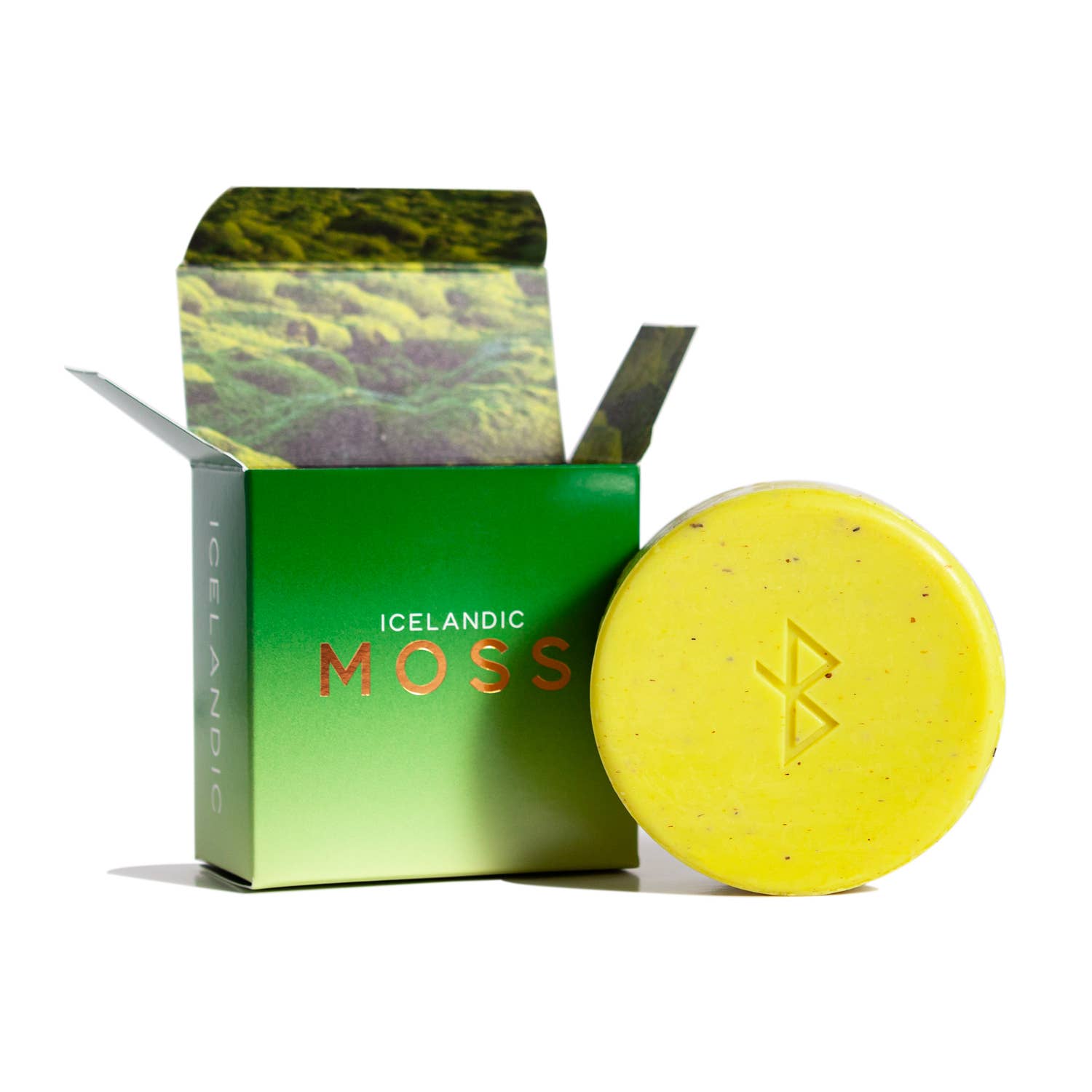 The Hallo Iceland Moss Soap in Gift Box is a round yellow bar with a symbol, paired with a green box labeled "Icelandic Moss" and moss imagery—perfect for eco-friendly skincare fans seeking natural soap.