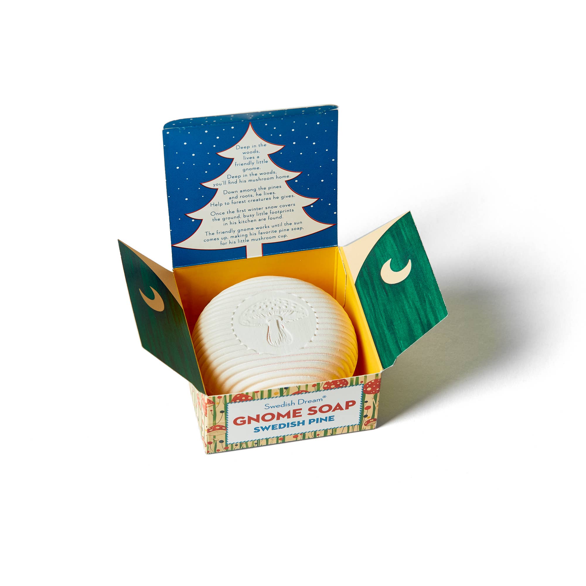 Open box displaying a round Swedish Dream Gnome Soap bar in Swedish Pine scent, proudly Vegan & Cruelty Free. Interior shows white tree on dark blue starry background; green packaging panels adorned with crescent moons.