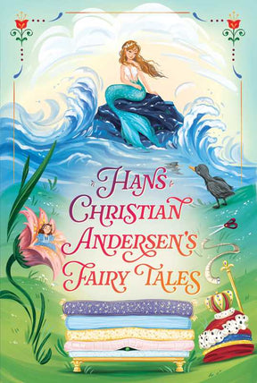 A vibrant hardcover book cover from Simon & Schuster features a mermaid perched on a rock, a fairy nestled in a flower, a black bird, and mattresses stacked high with a crown on top. The text reads: Hans Christian Andersen's Fairy Tales—a delightful 528-page collection of classic stories for ages 8 and up, perfect for enchanting bedtime reading.