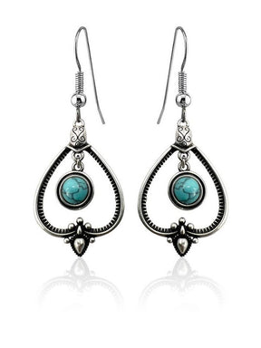 Handcrafted sterling silver earrings with teardrop frames and round turquoise stones—perfect for those who love Sterling Silver with Turquoise Drop Earrings.