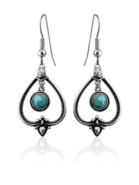 Handcrafted sterling silver earrings with teardrop frames and round turquoise stones—perfect for those who love Sterling Silver with Turquoise Drop Earrings.
