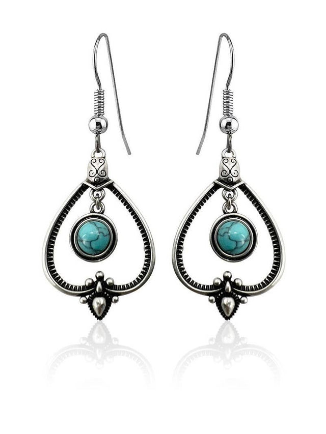 Handcrafted sterling silver earrings with teardrop frames and round turquoise stones—perfect for those who love Sterling Silver with Turquoise Drop Earrings.