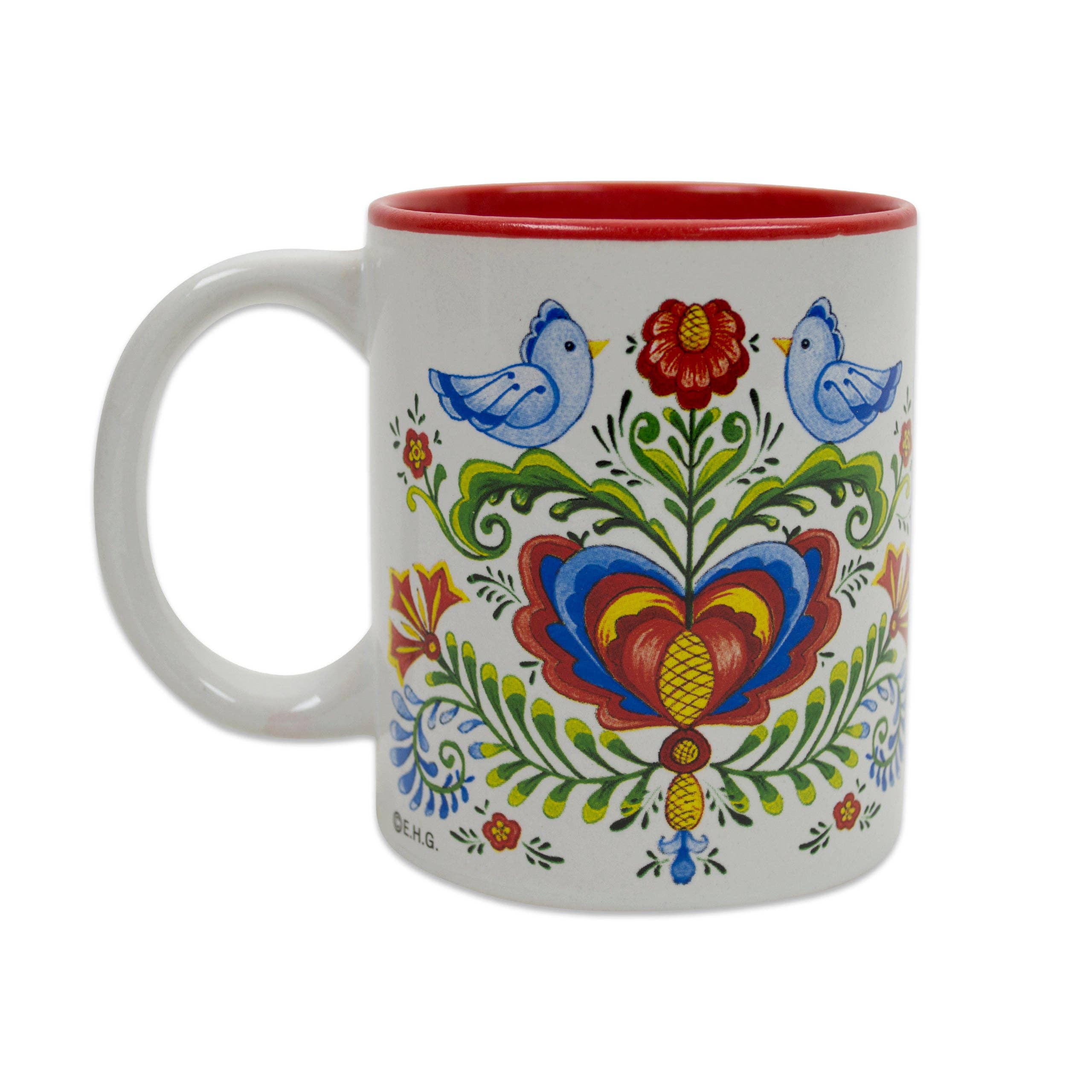 The "Rosemaling & Lovebirds Ceramic Coffee Mug" is a 12 oz white mug with a red interior, decorated in colorful Scandinavian folk art with two blue lovebirds, flowers, and symmetrical floral designs.