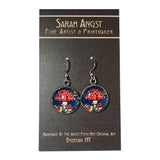 Earrings adorned with vibrant mushroom illustrations on a mini giclee print card, created by the renowned fine artist and printmaker from Bozeman, MT, Sarah Angst.