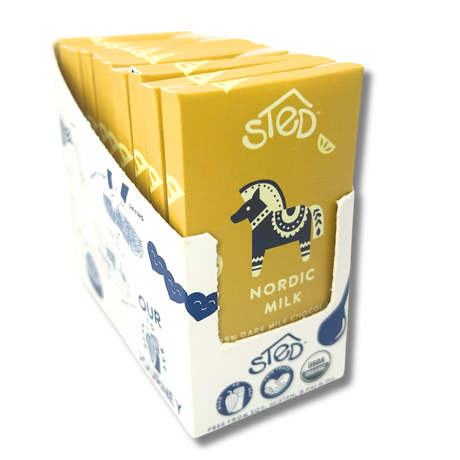 A box containing several yellow-wrapped Scandinavian chocolate bars, each with a horse illustration and “Sted Nordic Milk 55%” printed on the front.