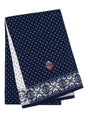 Introducing the stunning Norlender Knitwear "Snowflake Navy" Scarf, a folded blue and white Nordic masterpiece featuring an eye-catching pattern and a subtle emblem adorned with a red, white, and blue shield design. Crafted from 100% wool, this scarf effortlessly combines warmth and style in every thread.