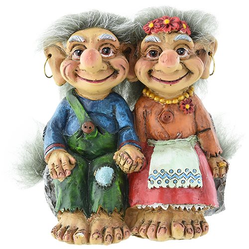 The Troll Couple Sitting figurines stand 4 inches tall, featuring a cheerful male in blue and green and a female adorned in orange with a flower headband and apron. These vibrant Norwegian-inspired trolls add whimsical charm to any space.