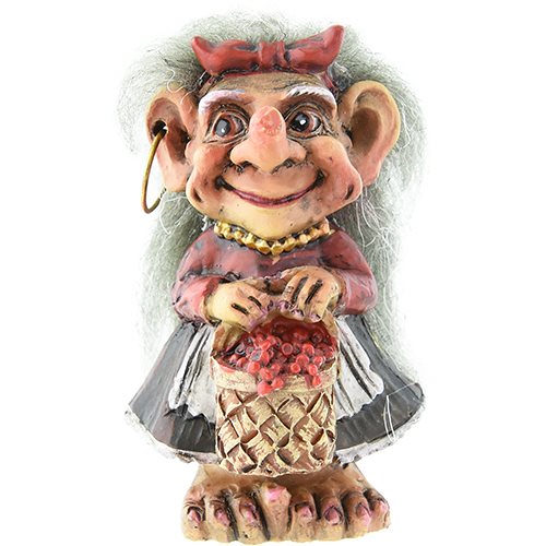 The Troll: Girl in Norwegian Dress with Lingonberry Basket 2 is a charming clay figurine depicting a troll with large ears, white hair, and traditional attire—a red bow and necklace, red shirt, gray skirt—holding a lingonberry basket. Its an ideal Norwegian souvenir.