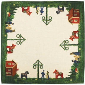 The Swedish Passport Co Table Runner: Swedish Midsommar (47.25"x15.7") features a cream background, green border, red houses, Dala horses, maypoles at each corner, and people in traditional Scandinavian dress; center is plain.