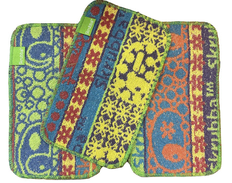 Three colorful Skrubba XL Scrub Cloths with abstract patterns and the Scrubbie logo overlap on a white background, providing effective, scratch-free cleaning.