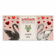 Rectangular OmNom Toffee + Sea Salt 60g wrapper, decorated with black and white origami swans, red hearts, and text reading White Caramelised Chocolate & Sea Salt and Reykjavik.