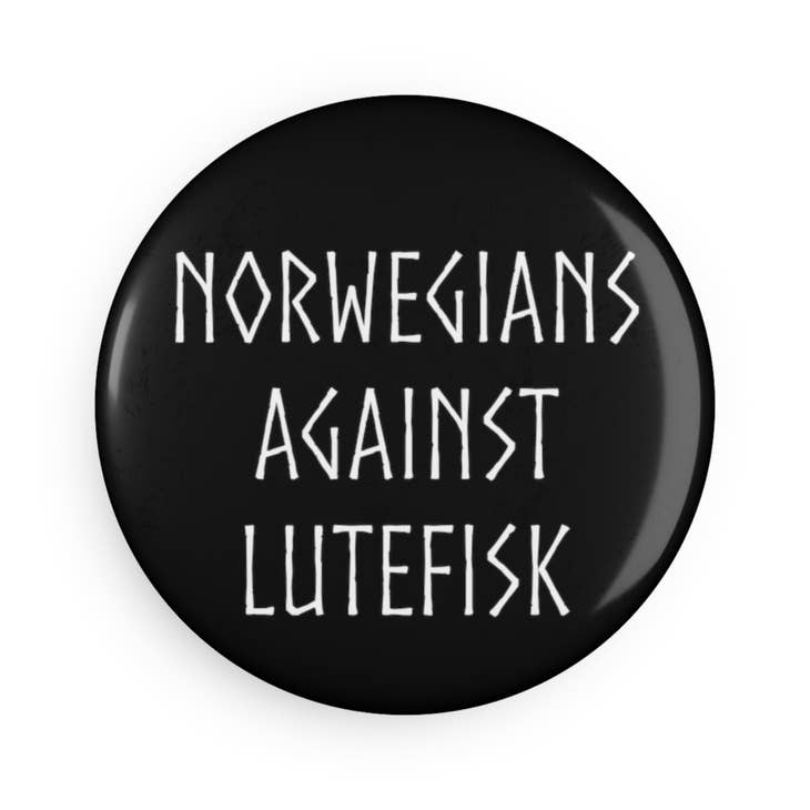 Round magnet with a bold white "Norwegians Against Lutefisk" design on a black background, measuring 2.25 inches.