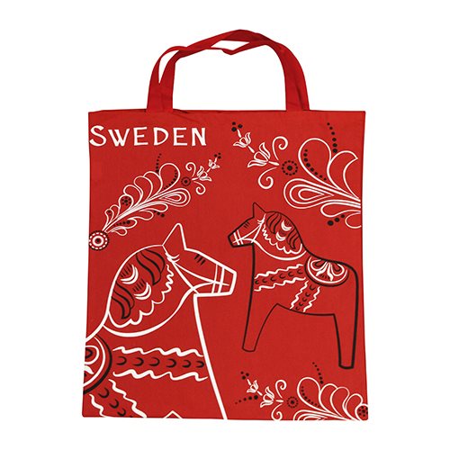 The Tote Bag: Red Swedish Bag with Dala Horses & Kurbits is a red cotton tote featuring “Sweden,” Dala horses, and white and black kurbits floral designs.
