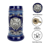 The Beer Stein: Blue Ceramic Beer Stein with Viking Metal Medallion Relief 20oz features an ornate design, sturdy handle, and a base logo. Circular icons detail the medallion, logo placement, and indicate hand wash only. Ideal for lovers of unique craftsmanship.