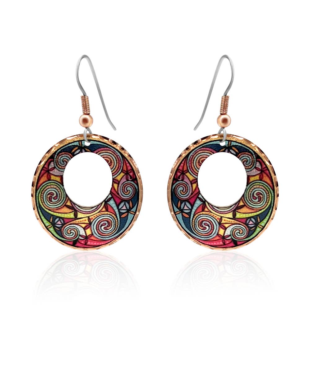 A pair of handcrafted copper drop earrings featuring a red, blue, and silver geometric cut-out design.