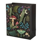 The Gift Bag: Dark Forest Mushroom Bag (7.5"w x 9"h x 3.5"d) is a black printed gift bag featuring green handles and decorated with mystical elements such as whimsical mushrooms, ferns, stars, a crescent moon, and a moth.