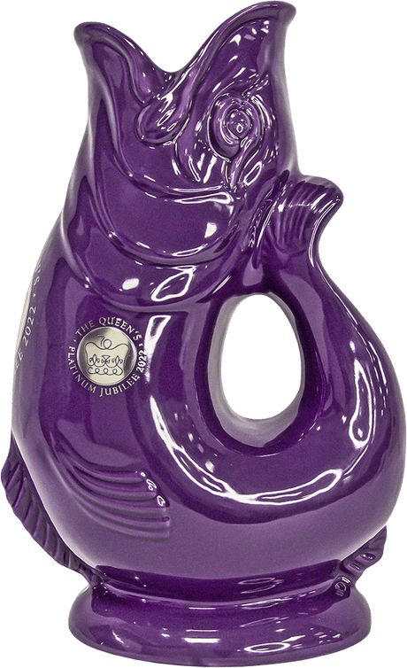 The Gluggle Jug: Limited Edition Queens Jubilee Gluggle Jug Extra Large is a glossy purple, fish-shaped ceramic pitcher featuring a Platinum Jubilee 2022 crest—an eye-catching collectible for the Queen’s Jubilee.