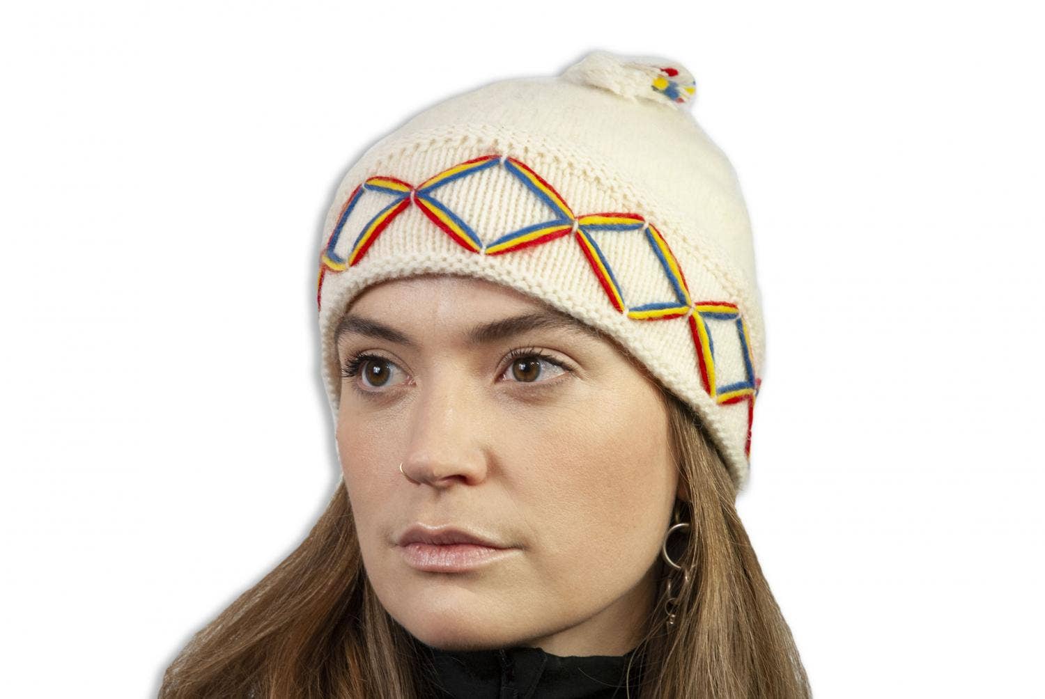 A person wearing a dark grey knitted beanie from Borjesson Handskar, designed with vibrant Nordic patterns.