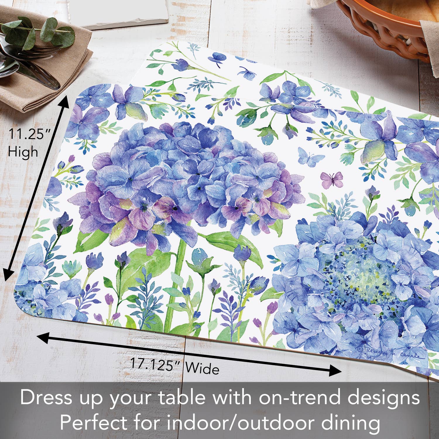 The "Placemat: Beautiful Hydrangea Reversible Rectangular Plastic Placemat" is made from BPA-free plastic and showcases blue and purple hydrangeas on a white background, measuring 11.25 inches high by 17.125 inches wide. It's perfect for both indoor and outdoor dining due to its durable design that allows for easy maintenance.