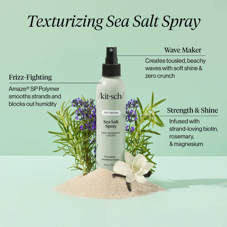 KITSCH Spray: Texturizing Sea Salt Hair Spray with Rosemary & Biotin (6 fl oz) is pictured on sand alongside rosemary, a flower, and vanilla beans—showcasing its frizz-fighting, wave-enhancing, and strengthening benefits with key ingredients like biotin, rosemary, and magnesium. This vegan hair product is the ideal beach waves spray for effortlessly tousled texture and extra volume.