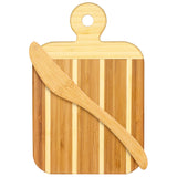 The Striped Paddle Serving and Cutting Board from our gift set, crafted with alternating light and dark stripes, features a convenient hole at the top edge. A wooden spreader knife rests diagonally across this versatile piece, making it perfect for both preparing and elegantly presenting your culinary creations.