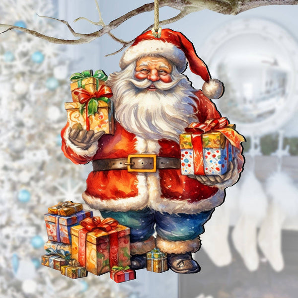 The Ornament: Merry Delivery Santa Wood Christmas Tree Ornament by artist G Debrekht features Santa holding wrapped gifts, with extra presents at his feet, set against a blurred white Christmas tree and stockings in the background.