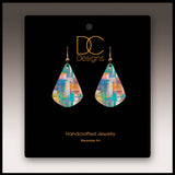 A pair of Mosaic Abstract Short Drop Handmade Earrings, teardrop-shaped, displayed on a black card labeled DC Designs Handcrafted Jewelry Wearable Art.