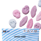 Sockerbit's Foamy Lips & Skulls Swedish Candy (2.8oz) features pink and white skull- and lip-shaped candies above a blue and white-striped SWEDISH CANDY bag with vegan, gluten free, and no artificial ingredients icons.