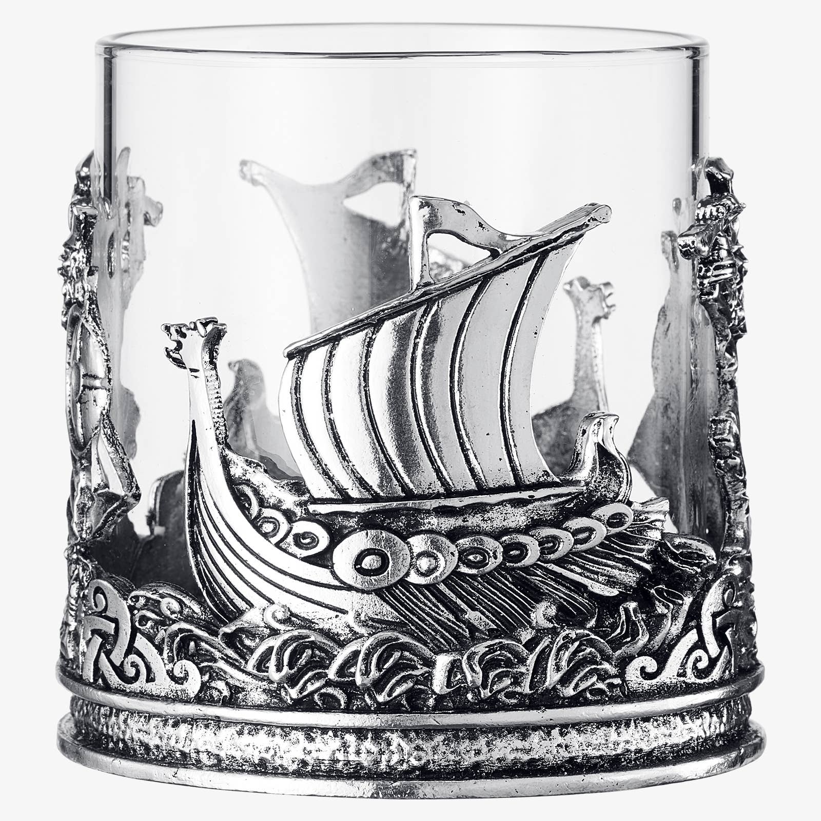 The 12 OZ Viking & Mythological Whiskey Drinking Glass features a clear design with ornate silver ship and wave motifs wrapping elegantly around its base and sides.
