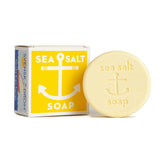 The Swedish Dream Sea Salt Lemon Soap, a 4 oz round bar with an anchor design and "sea salt soap" embossed, is shown next to its yellow and white box featuring an anchor graphic.