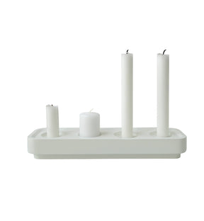 The Stumpastaken Swedish Candle Holder, made from recycled aluminum, elegantly features three upright white candles of varying heights and one horizontal candle, combining elegance with sustainability.