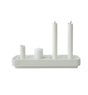 The Stumpastaken Swedish Candle Holder, made from recycled aluminum, elegantly features three upright white candles of varying heights and one horizontal candle, combining elegance with sustainability.