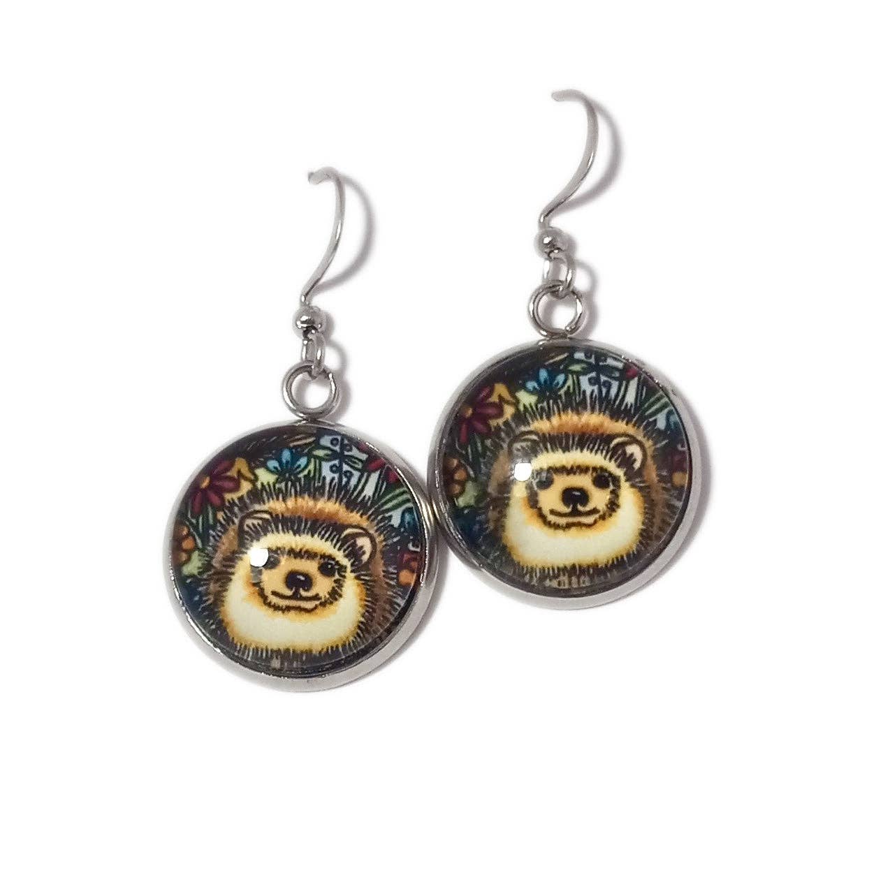 The whimsical essence is perfectly captured by the round handmade earrings named "Earrings: Hedgehog by Sarah Angst," featuring a charming hedgehog face set against a floral background.
