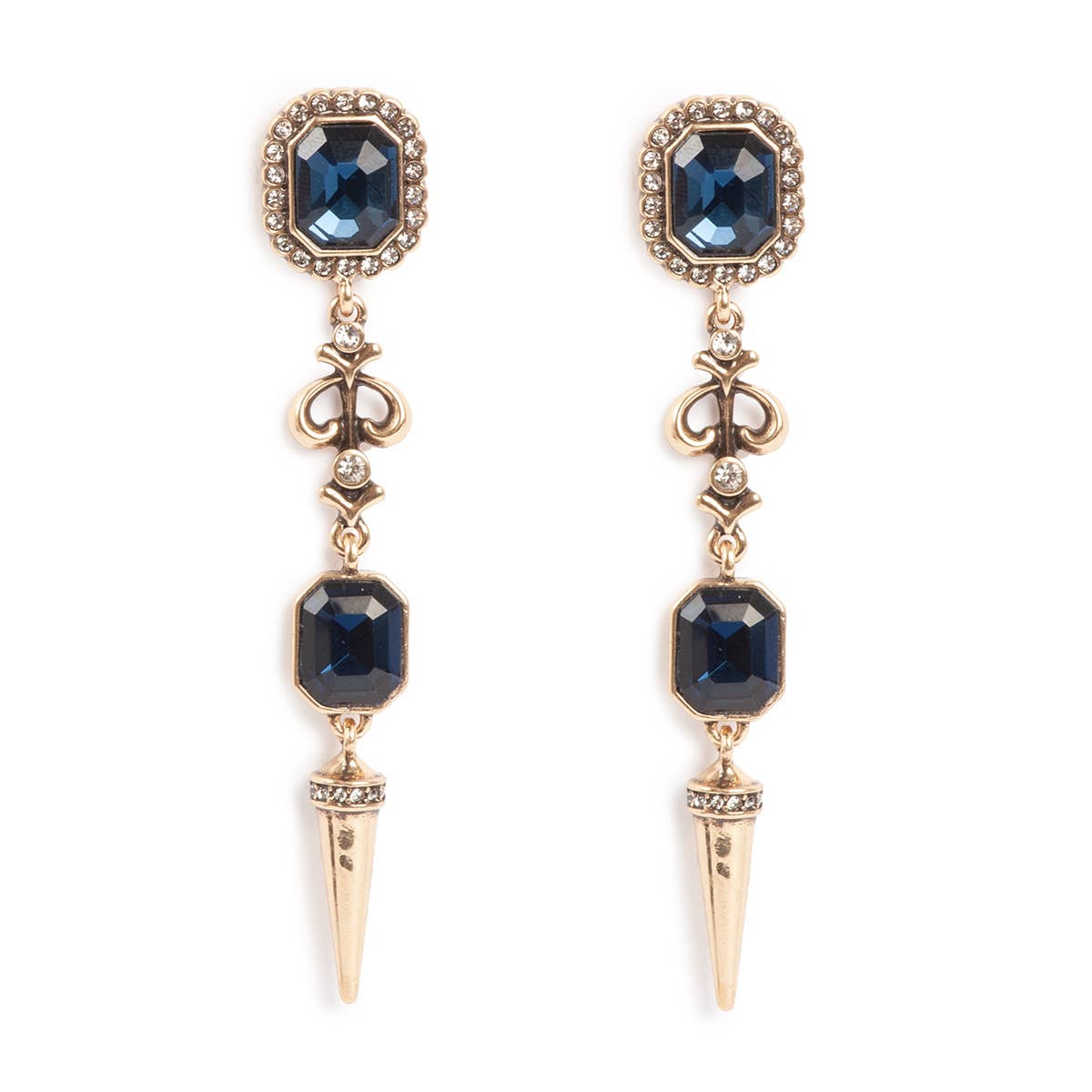 The A&C Oslo Antoinette Midnight Blue Statement Earrings are gold plated and feature midnight blue gemstones, fleur-de-lis details, and pointed spike pendants.