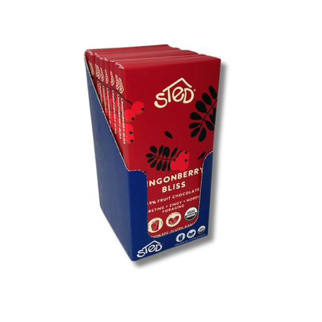 Several red-wrapped fruit chocolate bars stand upright in a blue display box, shown against a plain white background.