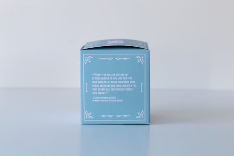 A light blue box with a white decorative border and a quote, featuring the Soap: Coastal Vibes Bath Bomb—handmade in Virginia Beach for skin nourishment—displayed against a plain white background.