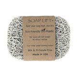 Soap Lift: The Original Soap Lift Soap Saver is a rectangular gray soap saver made from eco-friendly, intertwined bioplastic. BPA & phthalate free, it comes with a brown paper wrapper displaying product details.
