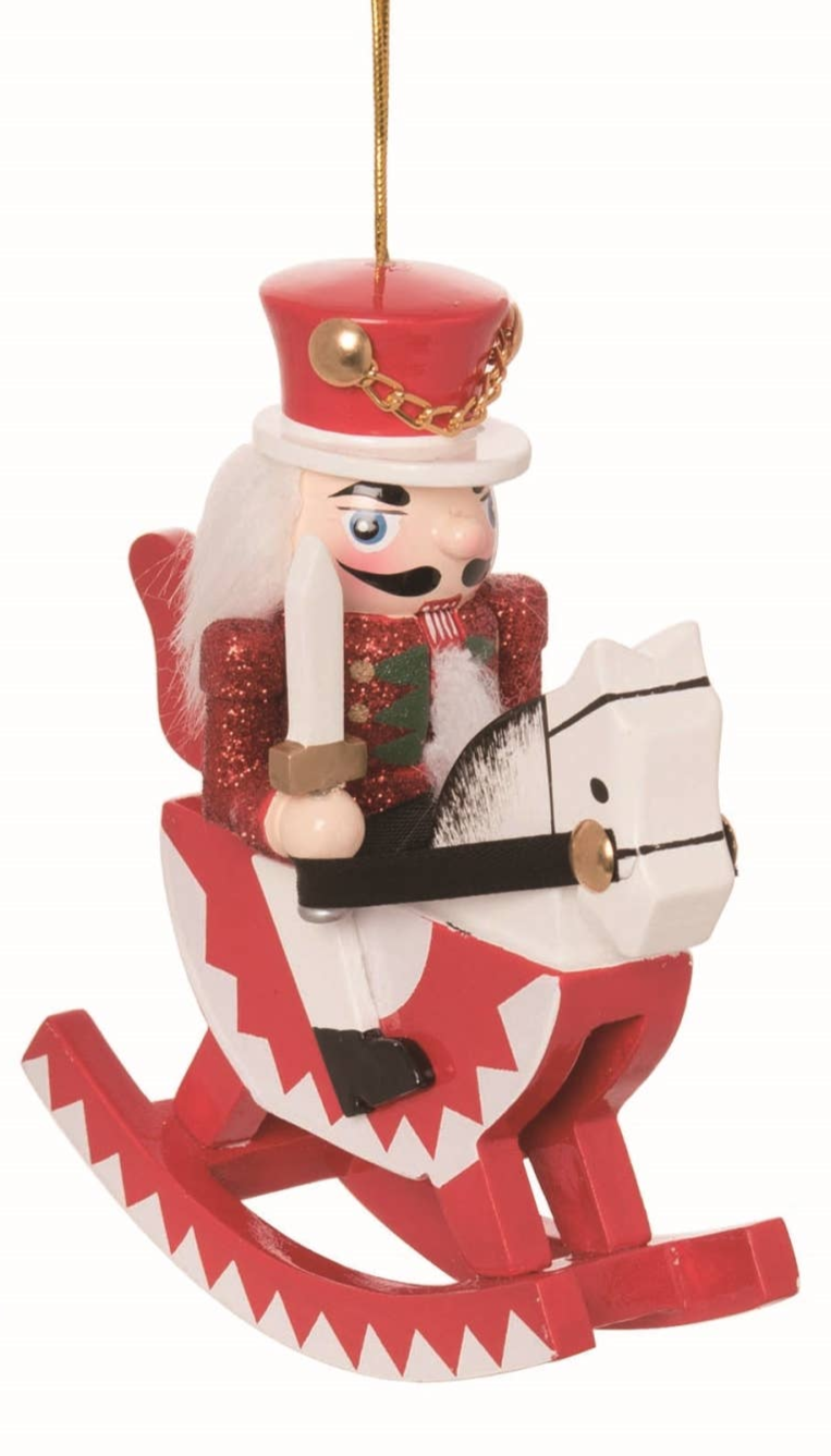 The Ornament: Wood Rocking Horse Nutcracker Ornament – 5 Holiday Decor features a red-and-white nutcracker riding a matching rocking horse with a gold hanging string—a festive Christmas tree ornament inspired by European tradition.