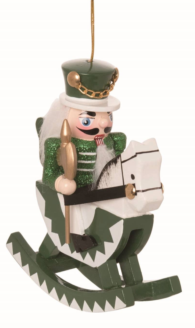The Ornament: Wood Rocking Horse Nutcracker Ornament – 5 Holiday Decor features a green and white wooden nutcracker soldier on a matching rocking horse, hanging by a gold string—a festive nod to classic European Christmas decor.