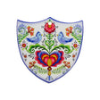 The Tile: Lovebirds Folk Art Cork Backed Ceramic Shield is a Nordic-designed wall decor featuring blue birds, vivid flowers, and symmetrical patterns—an ideal Swedish novelty gift to bring folk art charm to your home.