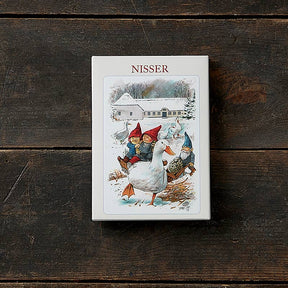 Product box labeled “Nisser” featuring three gnome-like children in red hats riding a goose, styled after traditional Scandinavian holiday art.