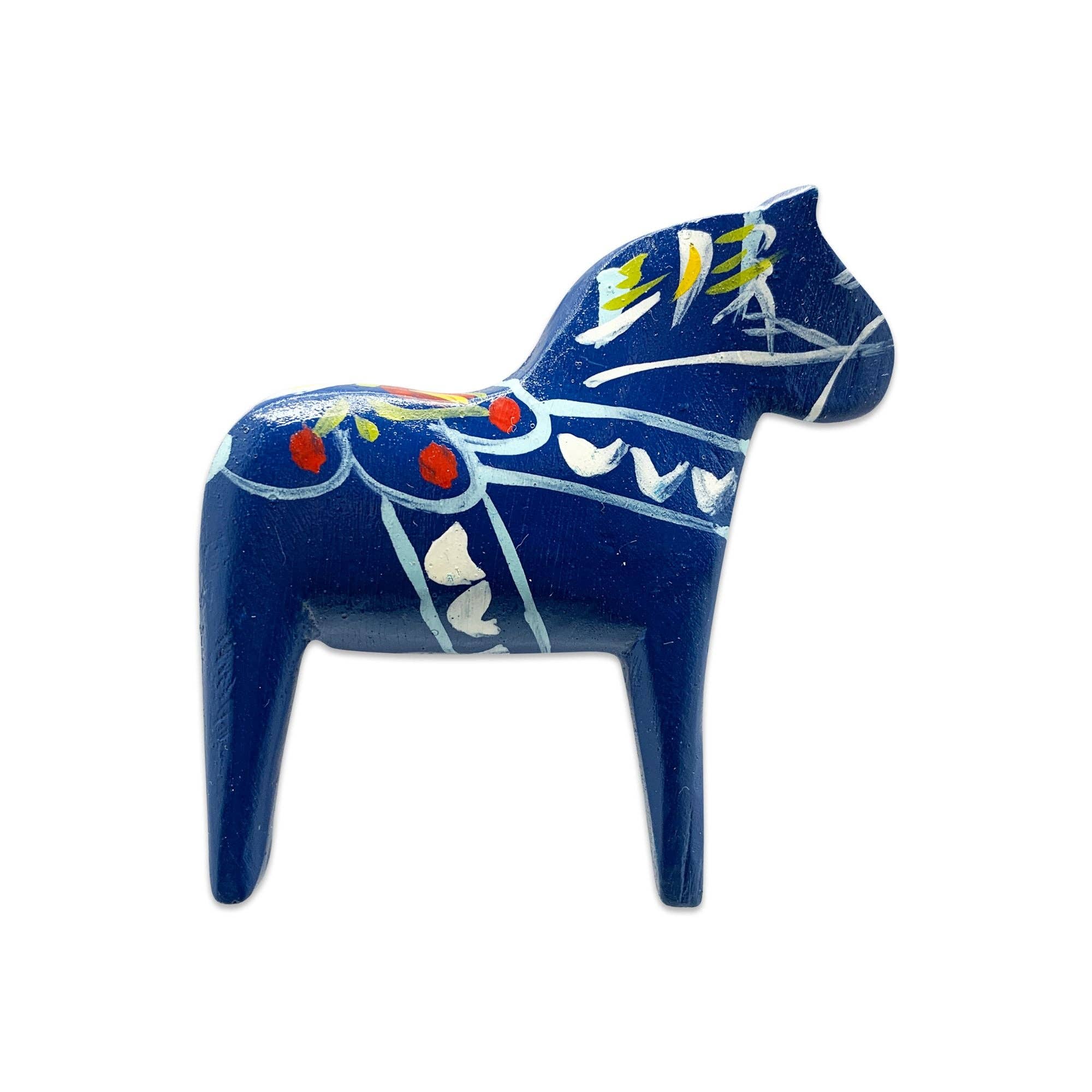 Blue Swedish Dala Horse refrigerator magnet, 3" tall by 2.75" wide, hand-painted with white, yellow, and red floral details—a charming souvenir and decorative accent for your fridge.